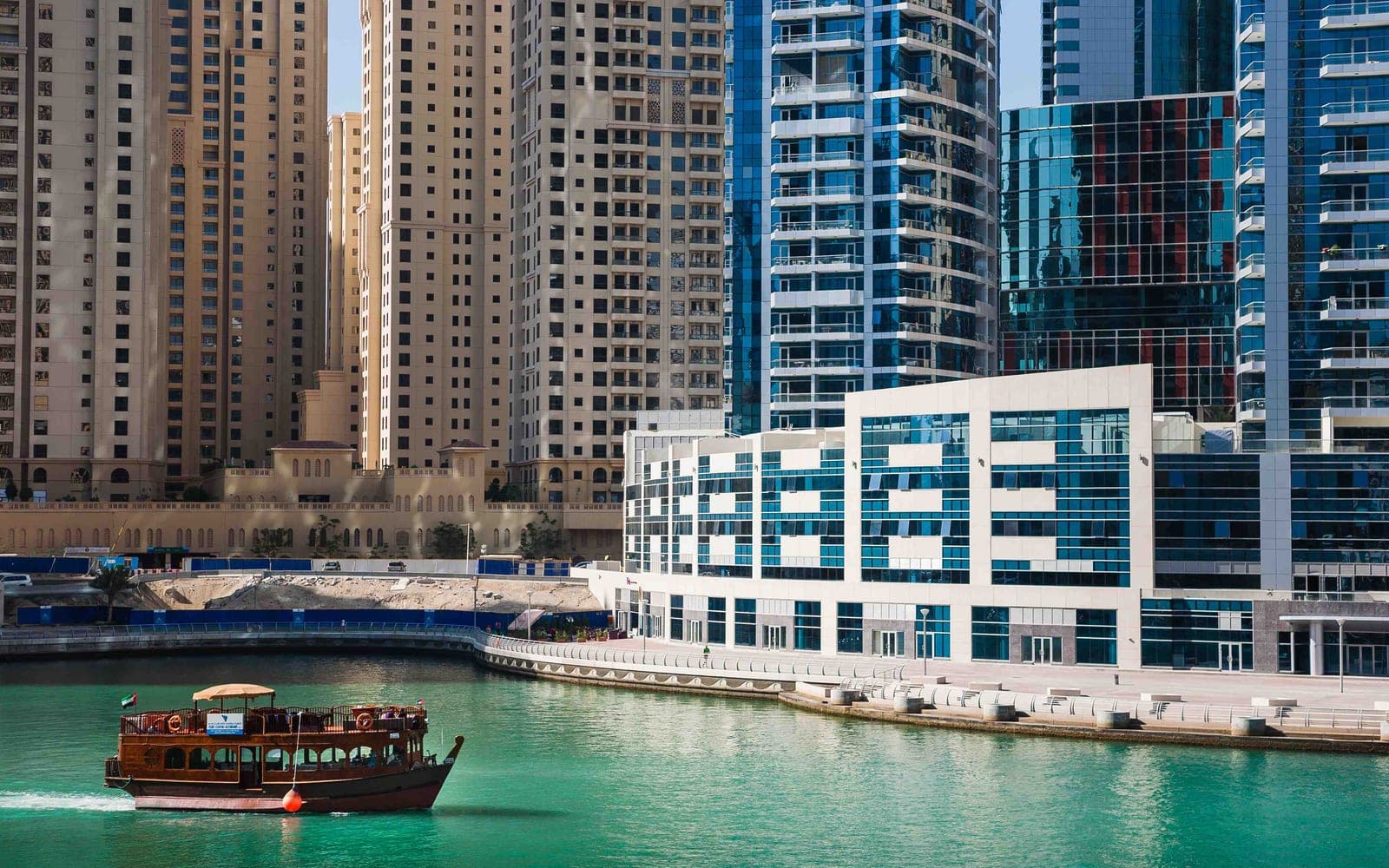Dubai Marina waterfront towers and a traditional dhow, a stop on a private city tour